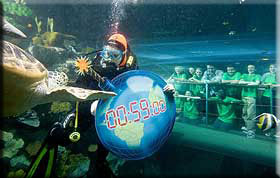 Pictured with naturalist and broadcaster Nick Baker as a diver carries a symbolic ‘time-bomb’ earth through the ocean tank at the National SEA LIFE Centre, are from left to right: Standing - Tierney Carter, Rebecca Johnson, Amber Rowland (Nick Baker), Ricky Froud, Matthew Newsome and Abigale Rudland. Kneeling - Molly Clayton, Hannah Layton and Kwabe Tenkorang.  Click on this photo to see a larger version >>>