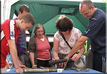 Explore the Seafloor Finds Table - the lady is holding part of a WW2 Machine Gun