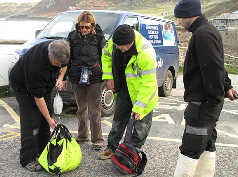 Dave Jarvis weighing the pup and assisted by Tim Bain and Kate Hockley
