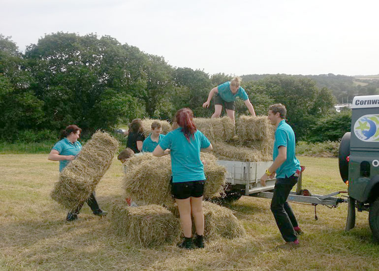 Some of the staff helping to get the hay onto the trailer