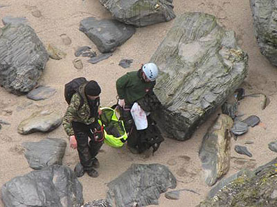 Tamara and Tim have the seal and heading towards the cliff  - photo copyright of Sue Sayer of Cornwall Seal Group