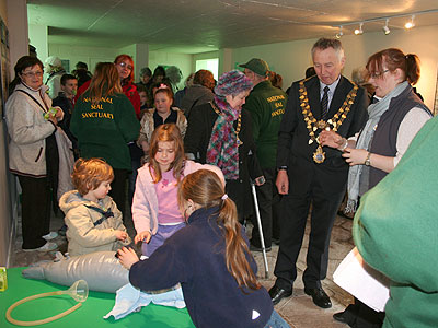 Sarah Vine, the Sanctuary's Attraction Manager and the Mayor of Helston watch a demonstration on how to be rescue volunteer